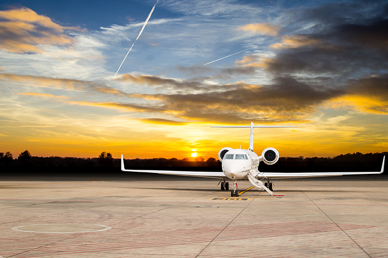 Private jet on tarmac for luxury ground transportation